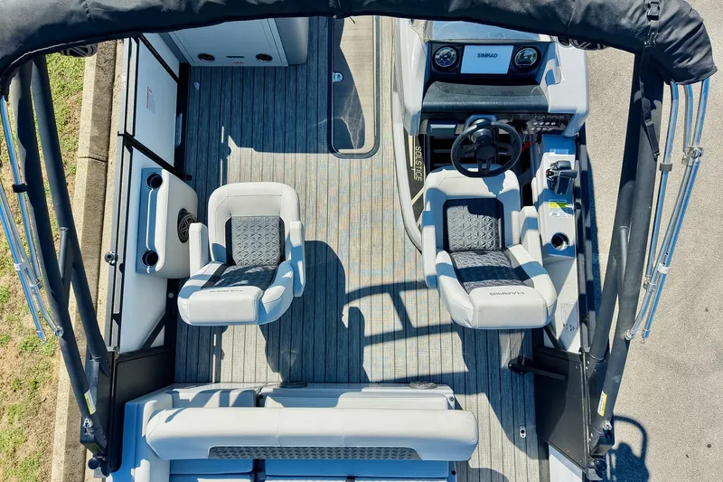 Slide: The Image of 2025 Harris Solstice 230 boat interior with modern seating and steering console. - 32