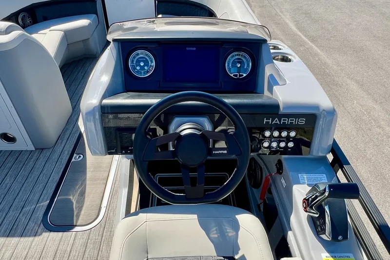 Slide: The Image of 2025 Harris Solstice 230 boat dashboard with steering wheel and control panel. - 35