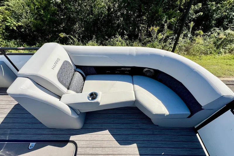 Slide: The Image of Luxurious seating on 2025 Harris Solstice 230 pontoon boat, featuring plush upholstery and cup holder. - 27