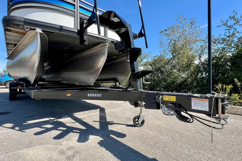 Slide: The Image of 2025 Harris Solstice 230 pontoon boat on trailer, sunny day, outdoor setting. - 58