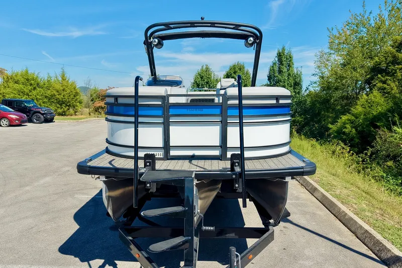 Slide: The Image of 2025 Harris Solstice 230 pontoon boat on trailer, parked outdoors on a sunny day. - 5