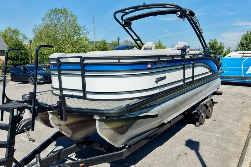 Slide: The Image of 2025 Harris Solstice 230 pontoon boat on trailer in sunny outdoor setting. - 7