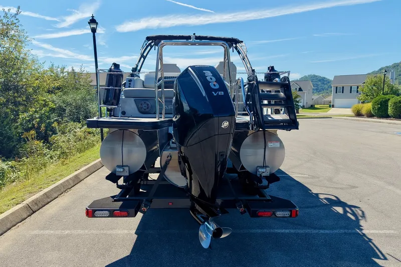 Slide: The Image of 2025 Harris Solstice 230 pontoon boat with powerful V8 engine, parked outdoors. - 14