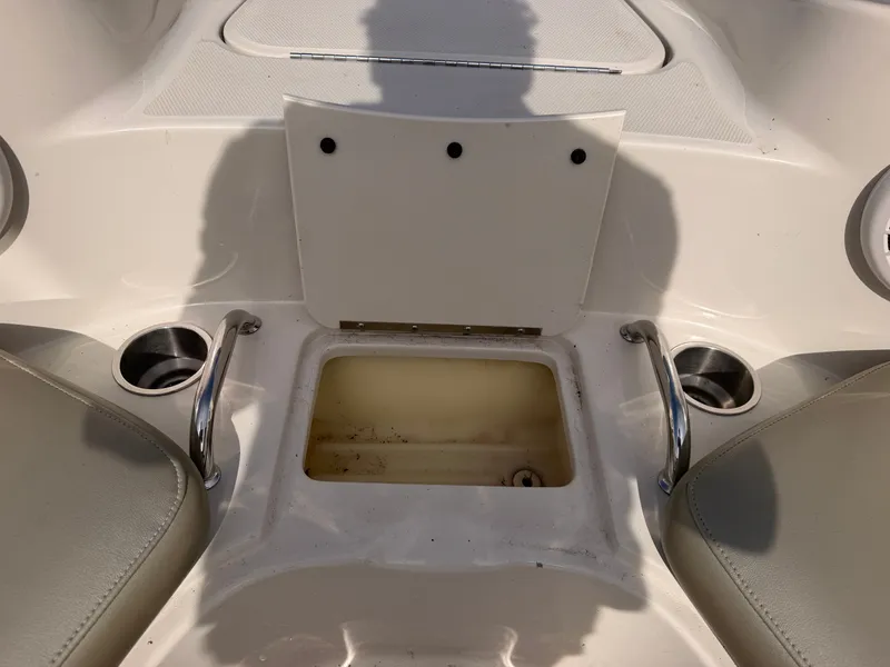 Slide: The Image of The image shows the seating area of a 2006 Sea Ray 220 Sundeck boat with cup holders. - 49