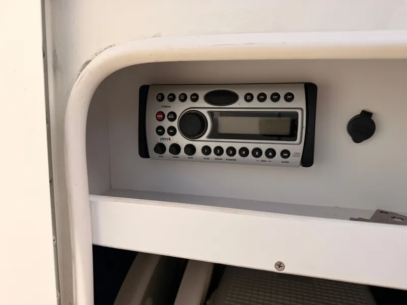 Slide: The Image of A radio is installed in a white compartment, surrounded by smooth surfaces. - 38
