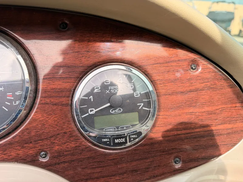 Slide: The Image of Close-up of a tachometer on a wooden dashboard. - 31