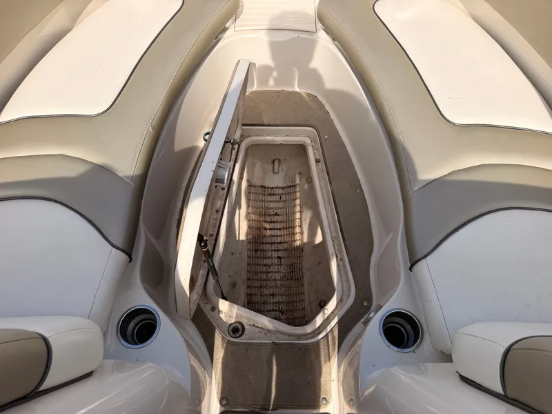 Slide: The Image of The image shows the open storage compartment of a 2006 Sea Ray 220 Sundeck boat. - 42