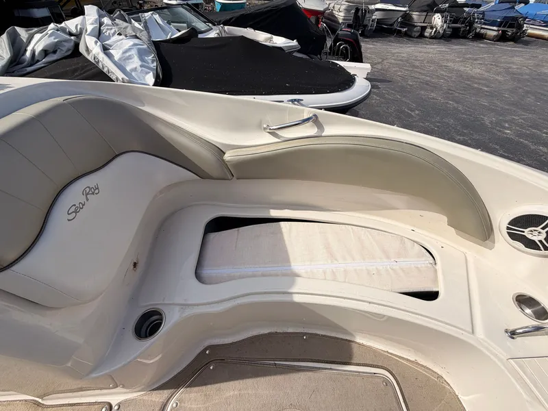 Slide: The Image of The image shows the cockpit of a 2006 Sea Ray 220 Sundeck with beige upholstery. - 45