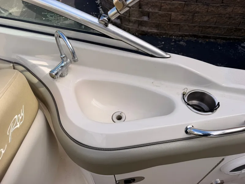Slide: The Image of A sink and cup holder on a 2006 Sea Ray 220 Sundeck boat. - 17