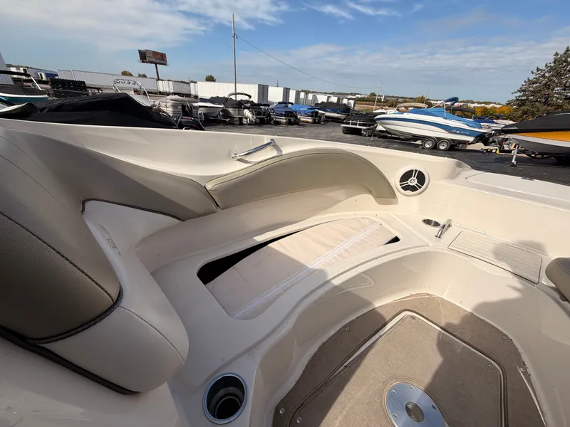 Slide: The Image of The image shows the cockpit of a 2006 Sea Ray 220 Sundeck with beige upholstery. - 44