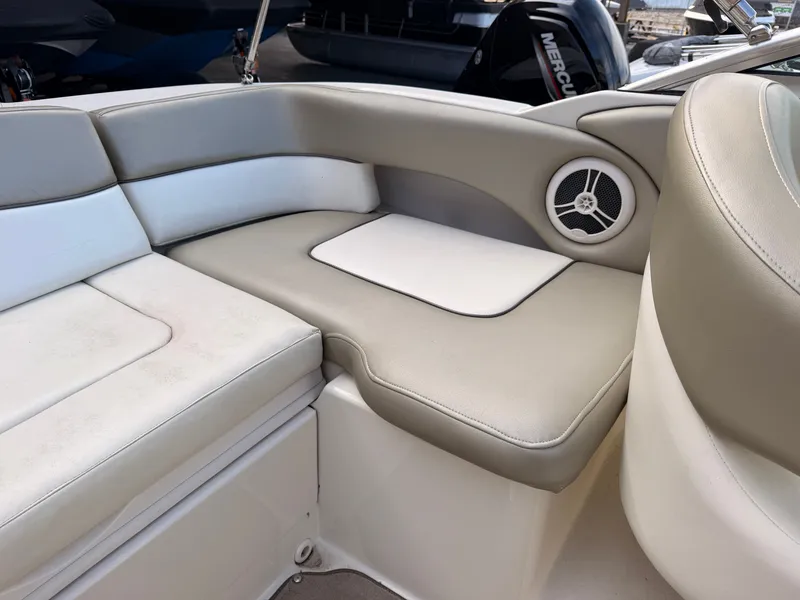 Slide: The Image of The 2006 Sea Ray 220 Sundeck features a cushioned seating area with a speaker. - 13
