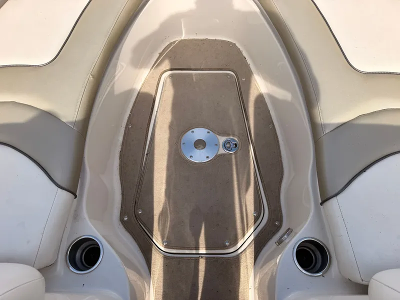 Slide: The Image of The image shows the bow area of a 2006 Sea Ray 220 Sundeck with beige carpeting. - 41
