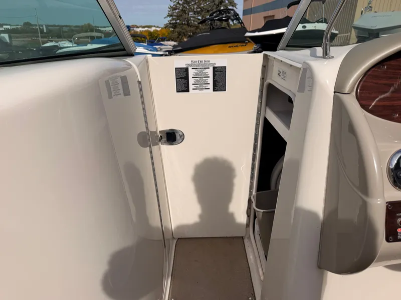 Slide: The Image of Interior view of a 2006 Sea Ray 220 Sundeck with storage and helm console. - 39