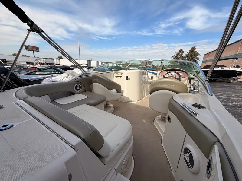 Slide: The Image of The image shows the interior of a 2006 Sea Ray 220 Sundeck boat with beige seating. - 9
