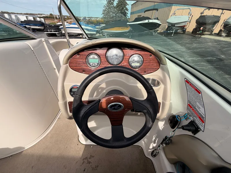 Slide: The Image of The image shows the cockpit of a 2006 Sea Ray 220 Sundeck with a sleek dashboard. - 26
