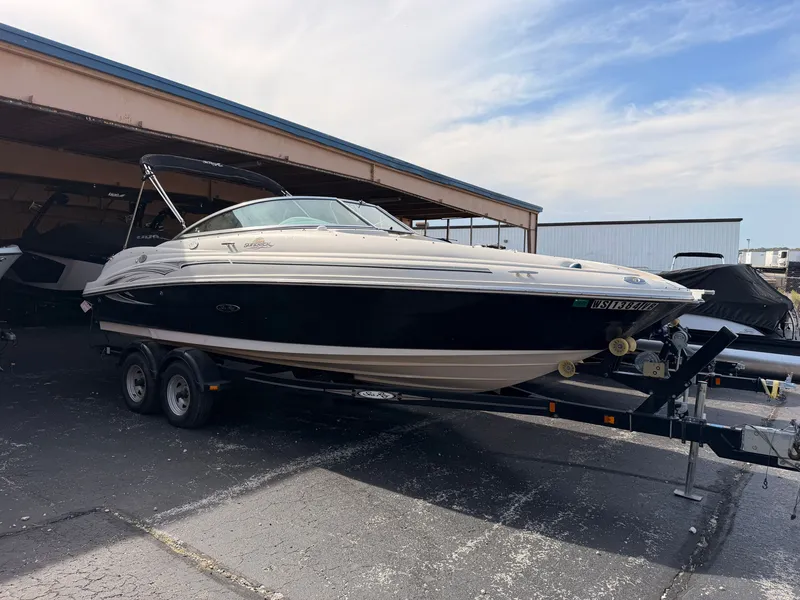 The Image of A 2006 Sea Ray 220 Sundeck on a trailer in a covered area. - 0
