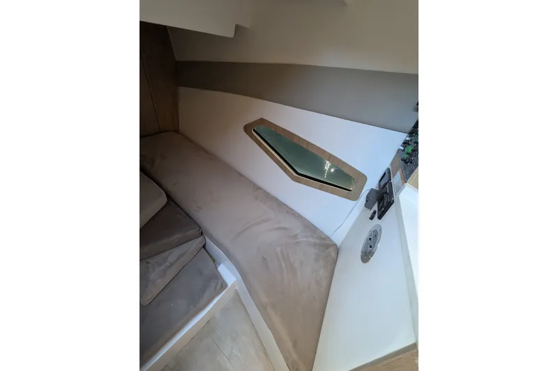 Slide: The Image of Interior of 2023 NX Boats 340 Sport Coupe with beige seating and modern design. - 33