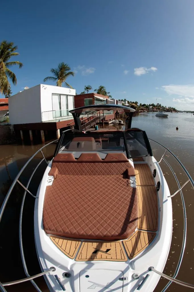 Slide: The Image of Manufacturer Provided Image: 2023 NX Boats 340 Sport Coupe docked by tropical waterfront. - 20