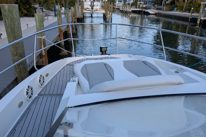 Slide: The Image of 2023 NX Boats 340 Sport Coupe docked, featuring sleek deck design and comfortable seating. - 11