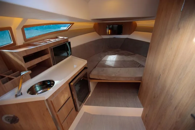 Slide: The Image of Manufacturer Provided Image: Luxurious interior of 2023 NX Boats 340 Sport Coupe with modern amenities. - 17