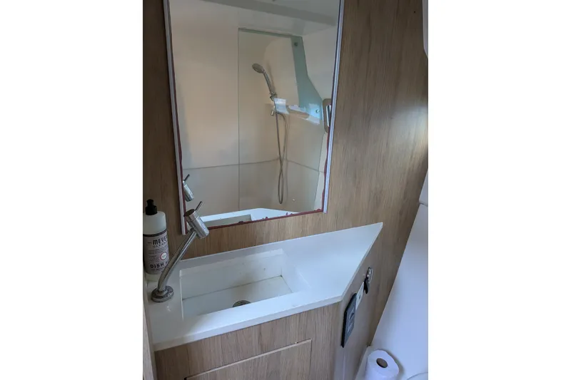 Slide: The Image of Bathroom interior of 2023 NX Boats 340 Sport Coupe with sink and shower. - 34