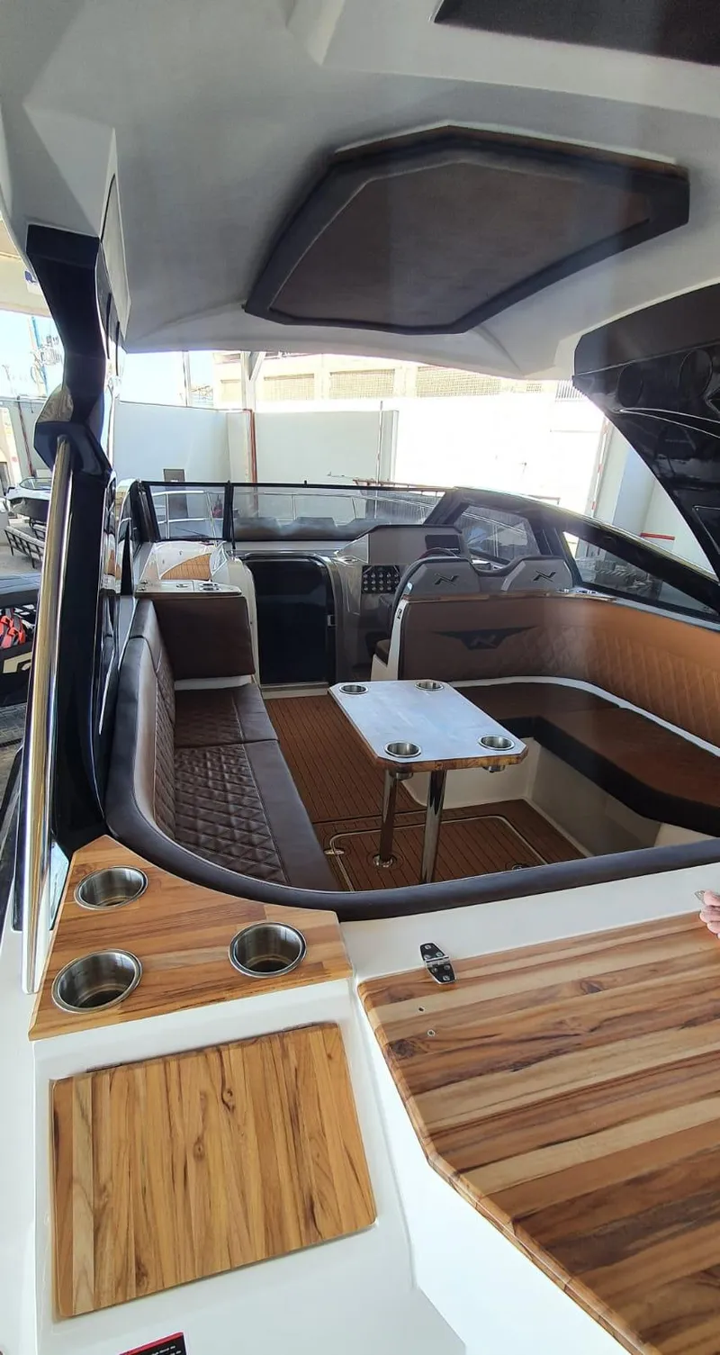 Slide: The Image of Manufacturer Provided Image: 2023 NX Boats 340 Sport Coupe interior with modern design and wood accents. - 19