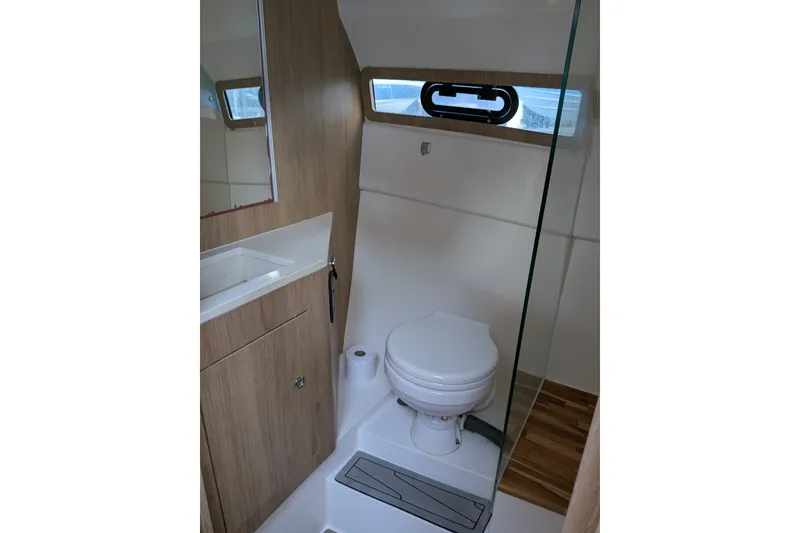 Slide: The Image of Modern bathroom interior in 2023 NX Boats 340 Sport Coupe, featuring sleek design and wood accents. - 37