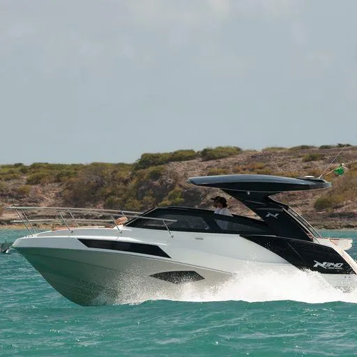 Slide: The Image of Manufacturer Provided Image: 2023 NX Boats 340 Sport Coupe cruising on turquoise water. - 13