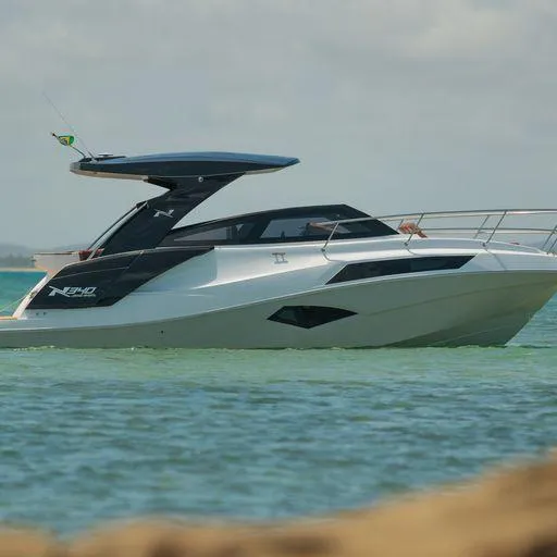 The Image of Manufacturer Provided Image: 2023 NX Boats 340 Sport Coupe on calm water, sleek design, modern luxury yacht. - 11