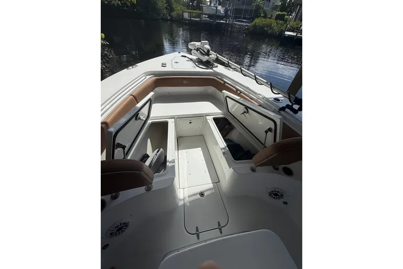 Slide: The Image of 2025 Sea Hunt Gamefish 27FS boat interior with open storage compartments. - 26