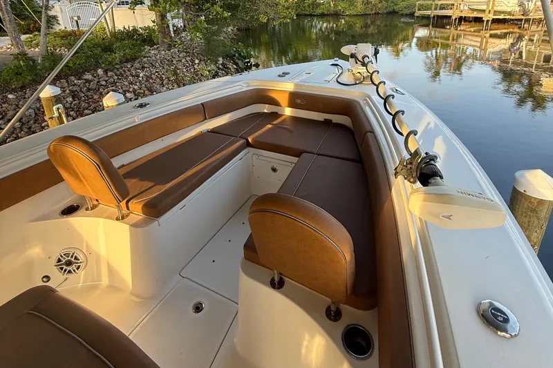 Slide: The Image of 2025 Sea Hunt Gamefish 27FS boat interior with brown seating and fishing rod holder. - 22