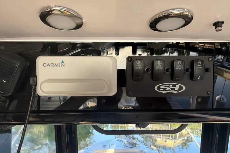 Slide: The Image of Control panel of 2025 Sea Hunt Gamefish 27FS with Garmin device and switches. - 36
