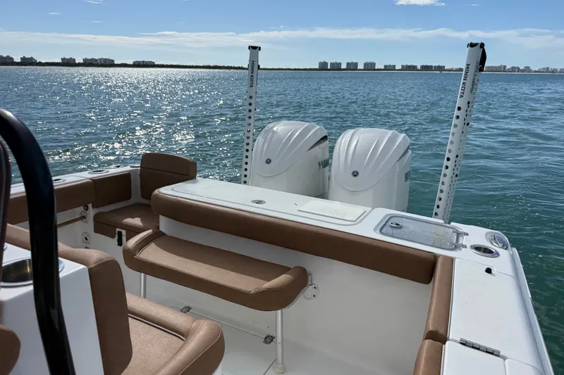 Slide: The Image of 2025 Sea Hunt Gamefish 27FS boat on water, featuring dual engines and comfortable seating. - 16
