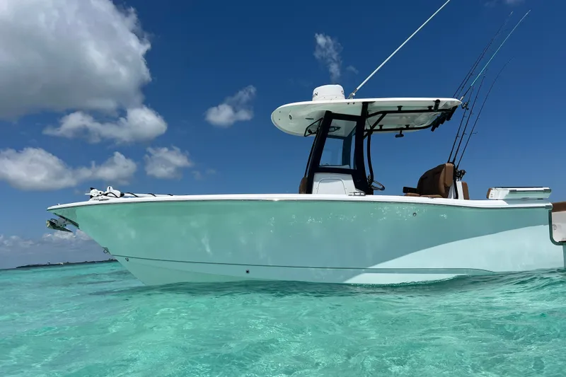 Slide: The Image of 2025 Sea Hunt Gamefish 27FS boat on clear turquoise water under blue sky. - 4