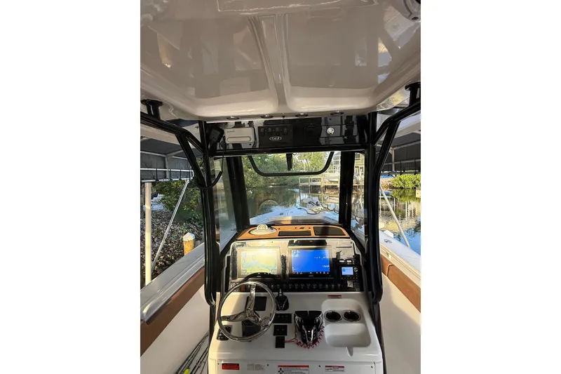 Slide: The Image of Interior view of 2025 Sea Hunt Gamefish 27FS boat cockpit with navigation screens. - 35