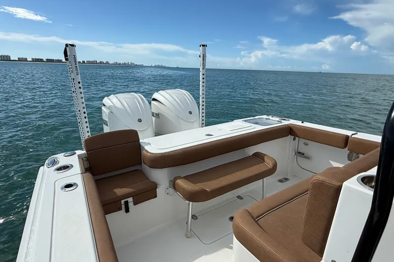 Slide: The Image of 2025 Sea Hunt Gamefish 27FS boat interior with brown seating, ocean view. - 17