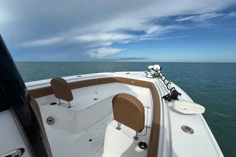 Slide: The Image of 2025 Sea Hunt Gamefish 27FS boat on open water under a partly cloudy sky. - 24
