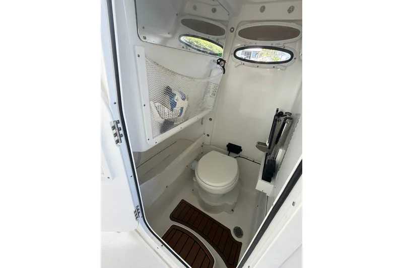 Slide: The Image of 2025 Sea Hunt Gamefish 27FS boat interior with toilet and storage features. - 39