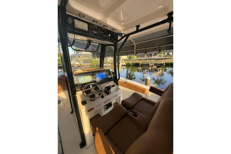 Slide: The Image of Interior view of 2025 Sea Hunt Gamefish 27FS boat with modern dashboard and seating. - 34