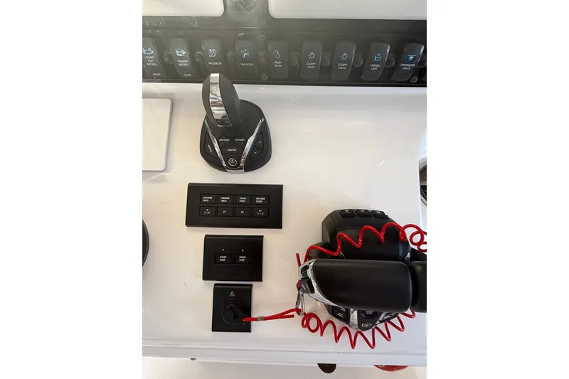 Slide: The Image of Control panel of 2025 Sea Hunt Gamefish 27FS boat with switches and throttle. - 33