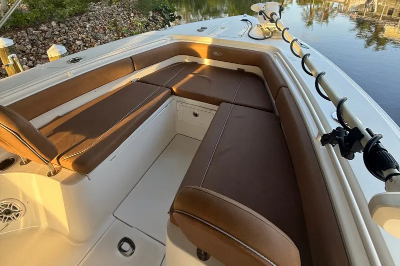 Slide: The Image of 2025 Sea Hunt Gamefish 27FS boat interior with brown cushioned seating. - 23