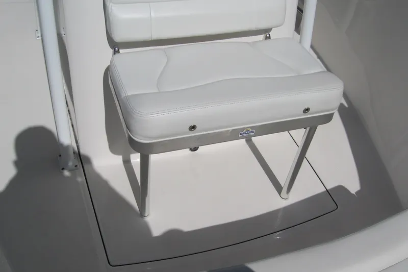 Slide: The Image of White cushioned seat on 2016 Edgewater 208CC boat, featuring sleek design and sturdy metal legs. - 3