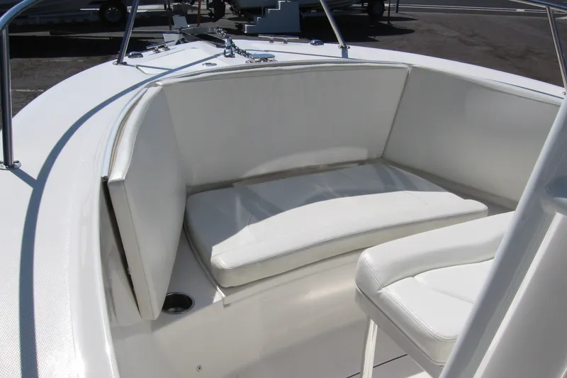 Slide: The Image of 2016 Edgewater 208CC boat interior with white cushioned seating. - 7