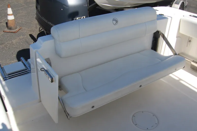 Slide: The Image of 2016 Edgewater 208CC boat with white cushioned seating and Yamaha 150 engine. - 6