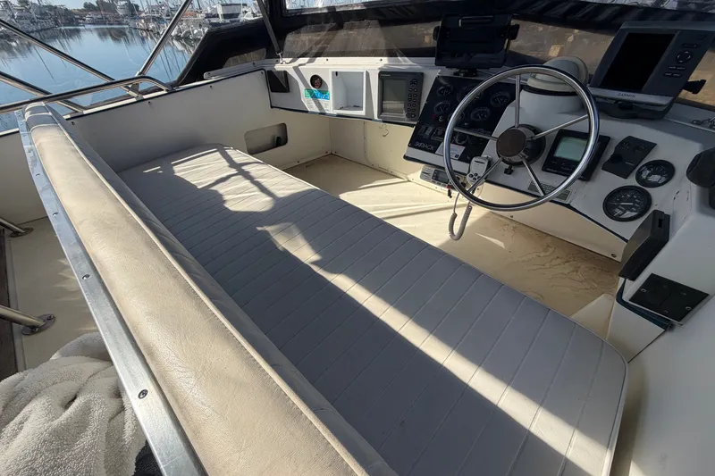Slide: The Image of 1994 Skipjack 262 Flybridge boat interior with steering wheel and control panel. - 15
