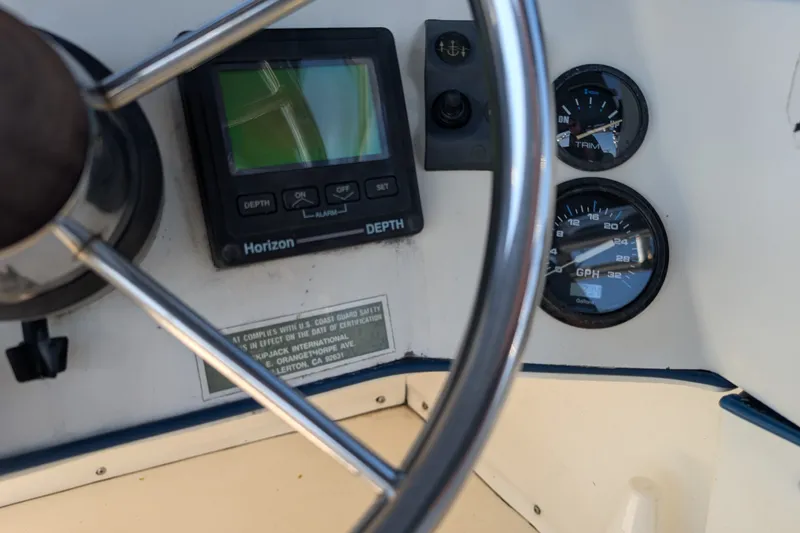 Slide: The Image of Steering wheel and dashboard instruments of 1994 Skipjack 262 Flybridge boat. - 21