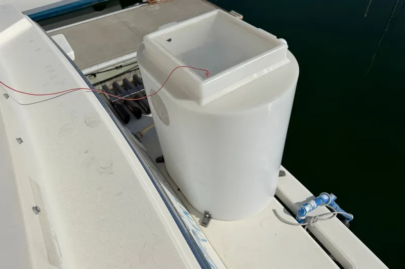 Slide: The Image of White container on a 1994 Skipjack 262 Flybridge boat deck near water. - 39