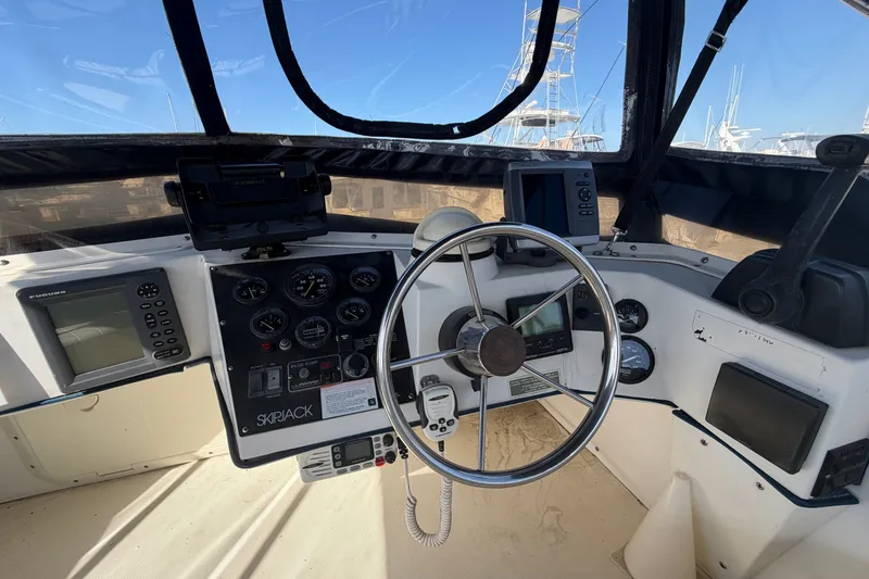 Slide: The Image of Helm of 1994 Skipjack 262 Flybridge boat with steering wheel and navigation instruments. - 16