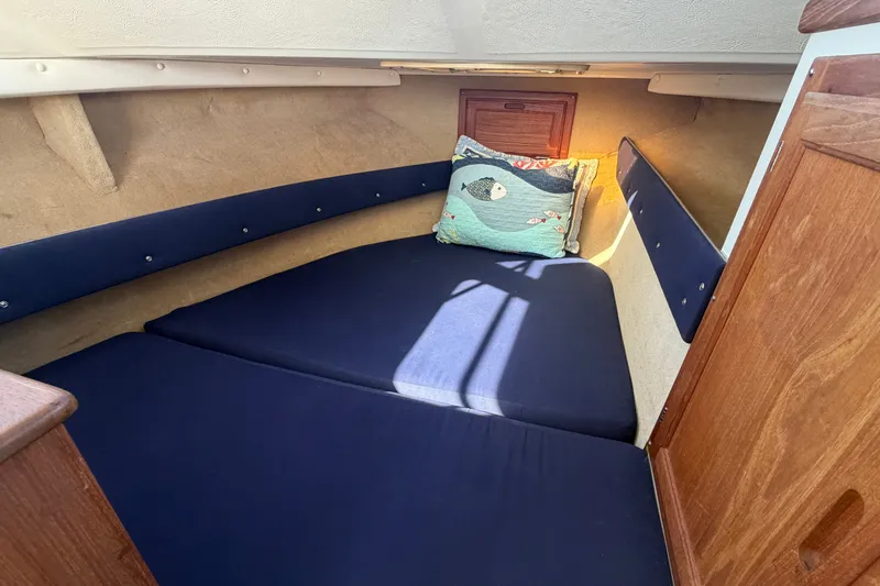 Slide: The Image of Cozy cabin interior of 1994 Skipjack 262 Flybridge with nautical-themed pillow. - 23