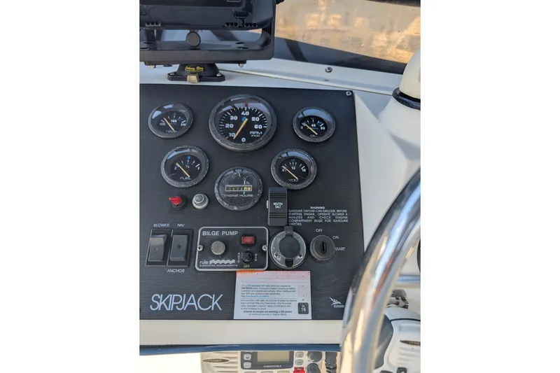 Slide: The Image of Control panel of a 1994 Skipjack 262 Flybridge boat with gauges and switches. - 19